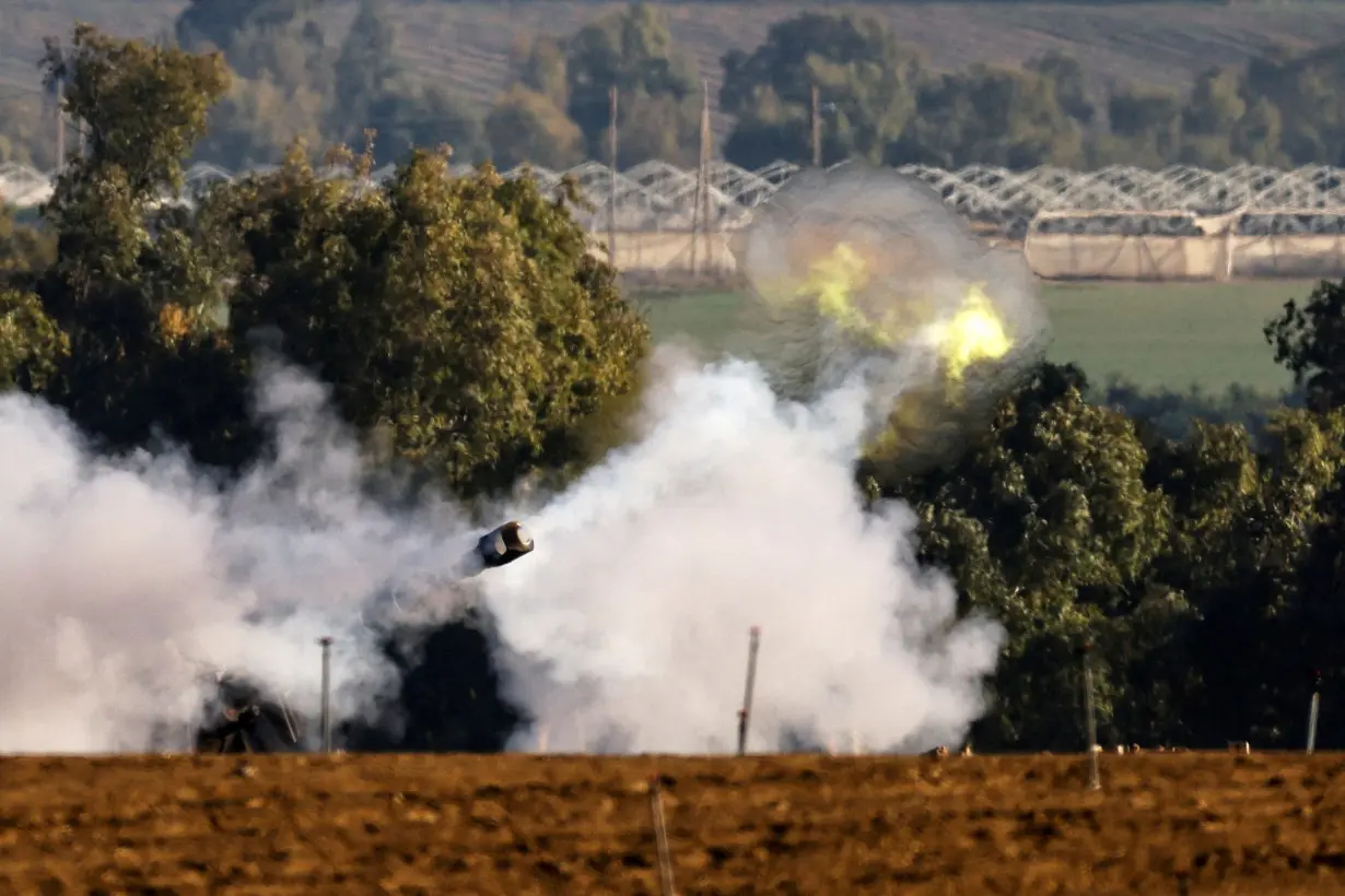 An Israeli artillery unit fires, amid the ongoing conflict between Israel and the Palestinian Islamist group Hamas, near the Israel-Gaza border