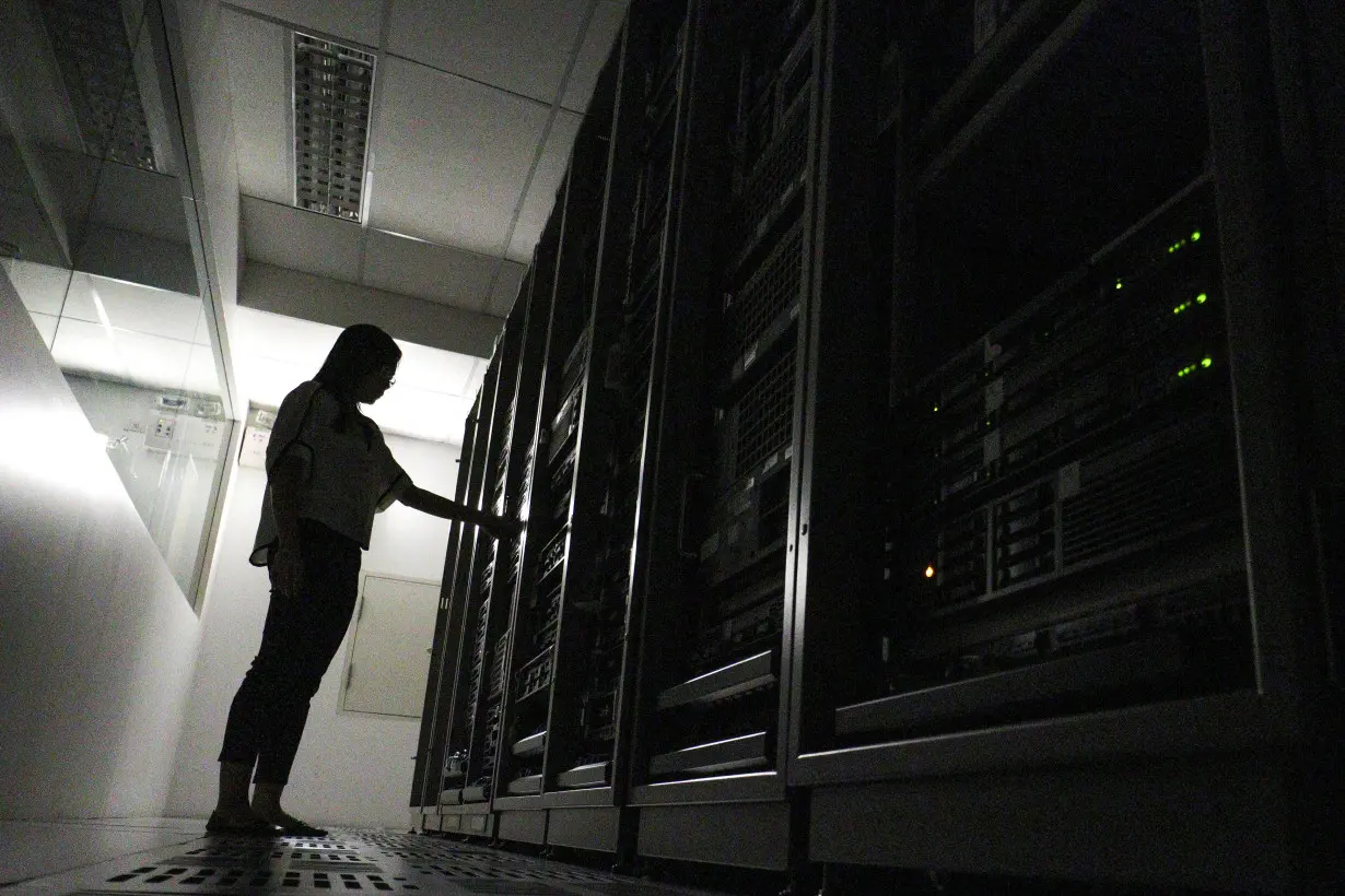 An employee works inside a server room at a company in Bangkok