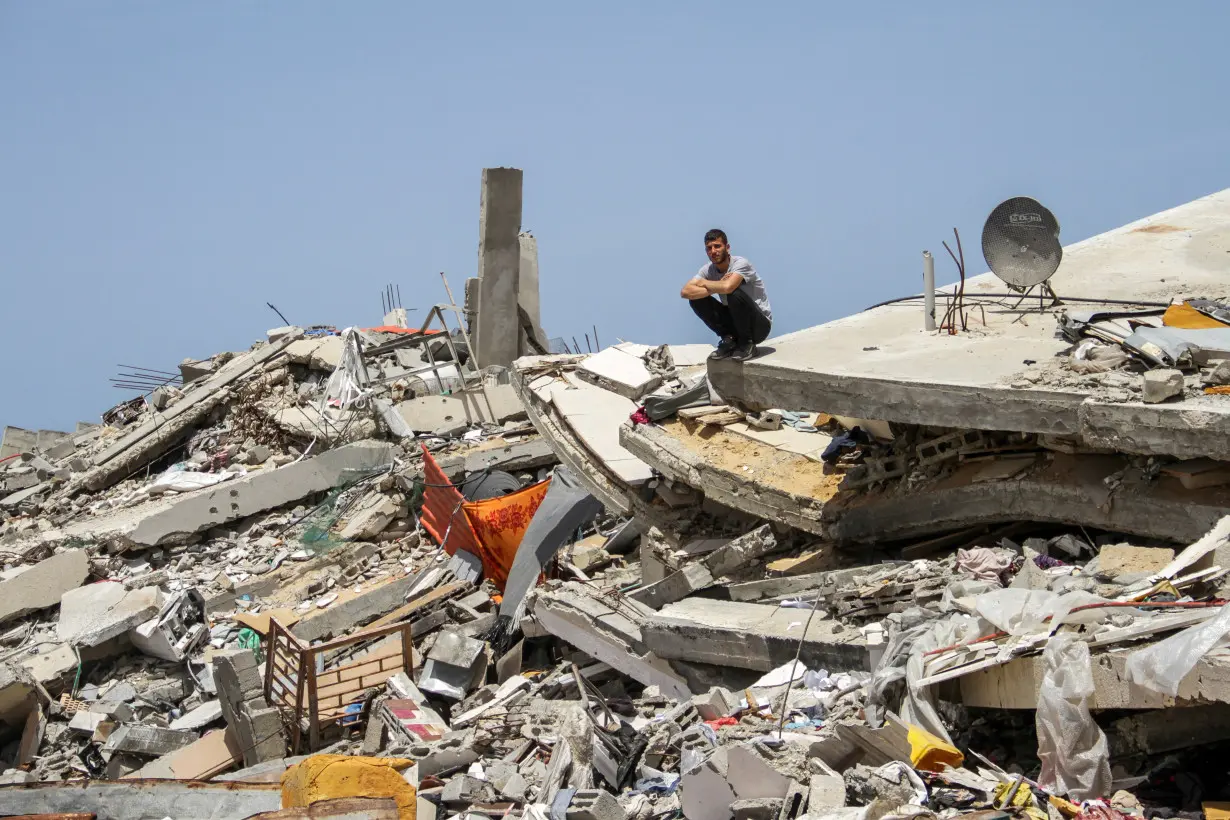 FILE PHOTO: A Palestinian man sits on the rubble of a house destroyed by Israeli strikes, amid the ongoing conflict between Israel and Hamas, in the northern Gaza Strip