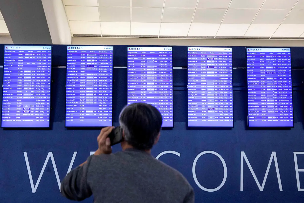 FILE PHOTO: Passengers wait for the flights to resume at Hartsfield-Jackson Atlanta International Airport in Atlanta