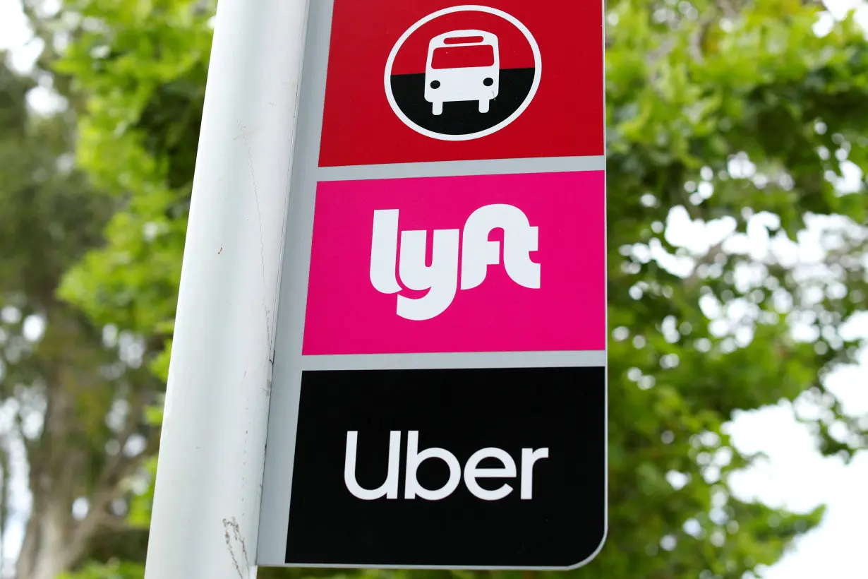 FILE PHOTO: A sign marks a rendezvous location for Lyft and Uber users at San Diego State University in San Diego