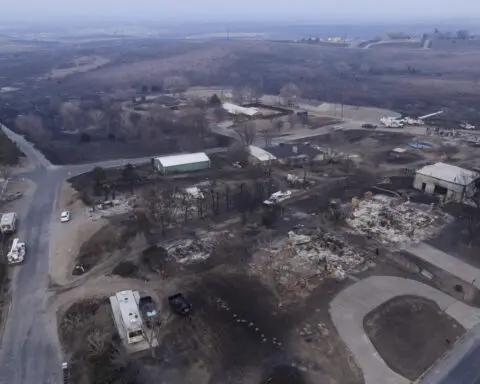 Flames menace multiple towns as wildfire grows into one of the largest in Texas history