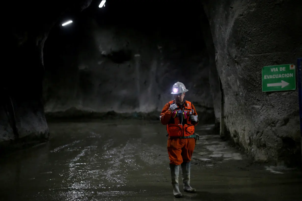 FILE PHOTO: A miner uses a walkie-talkie inside 'El Teniente' copper mine of Chile's state copper giant Codelco in Rancagua