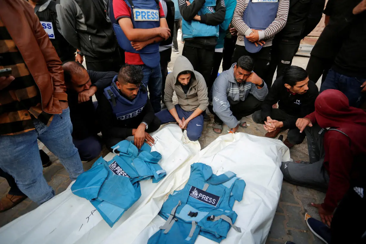 Palestinians mourn local journalists Hassouna Sleem and Sary Mansour, who were killed in an Israeli strike on a house, at a hospital in the central Gaza Strip