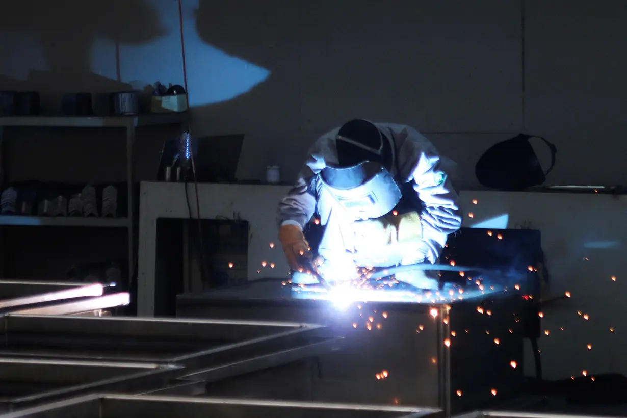 Employees work at Jingjin filter press factory in Dezhou