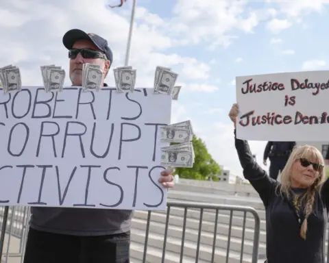 The Latest: Trump takes to social media before Supreme Court arguments