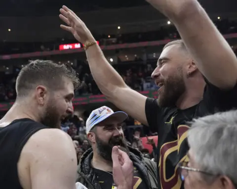 Travis and Jason Kelce attend bobblehead giveaway. Cavaliers give Jason a framed No. 62 jersey