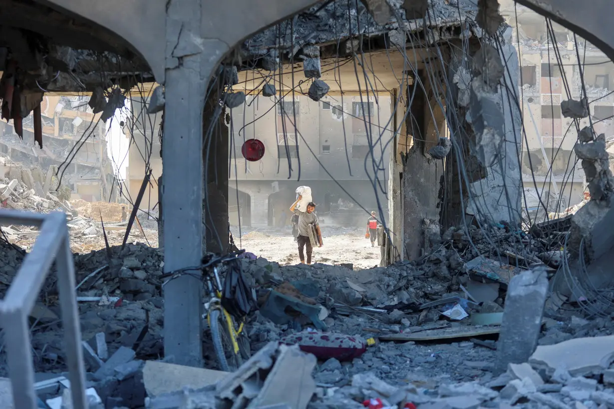 Palestinians inspect damages in Qatari-funded Hamad City following Israeli raid, in Khan Younis in the southern Gaza Strip