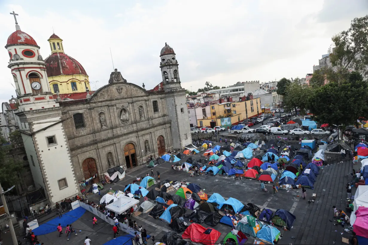 Migrants crowd Mexico City church in bustling makeshift shelter