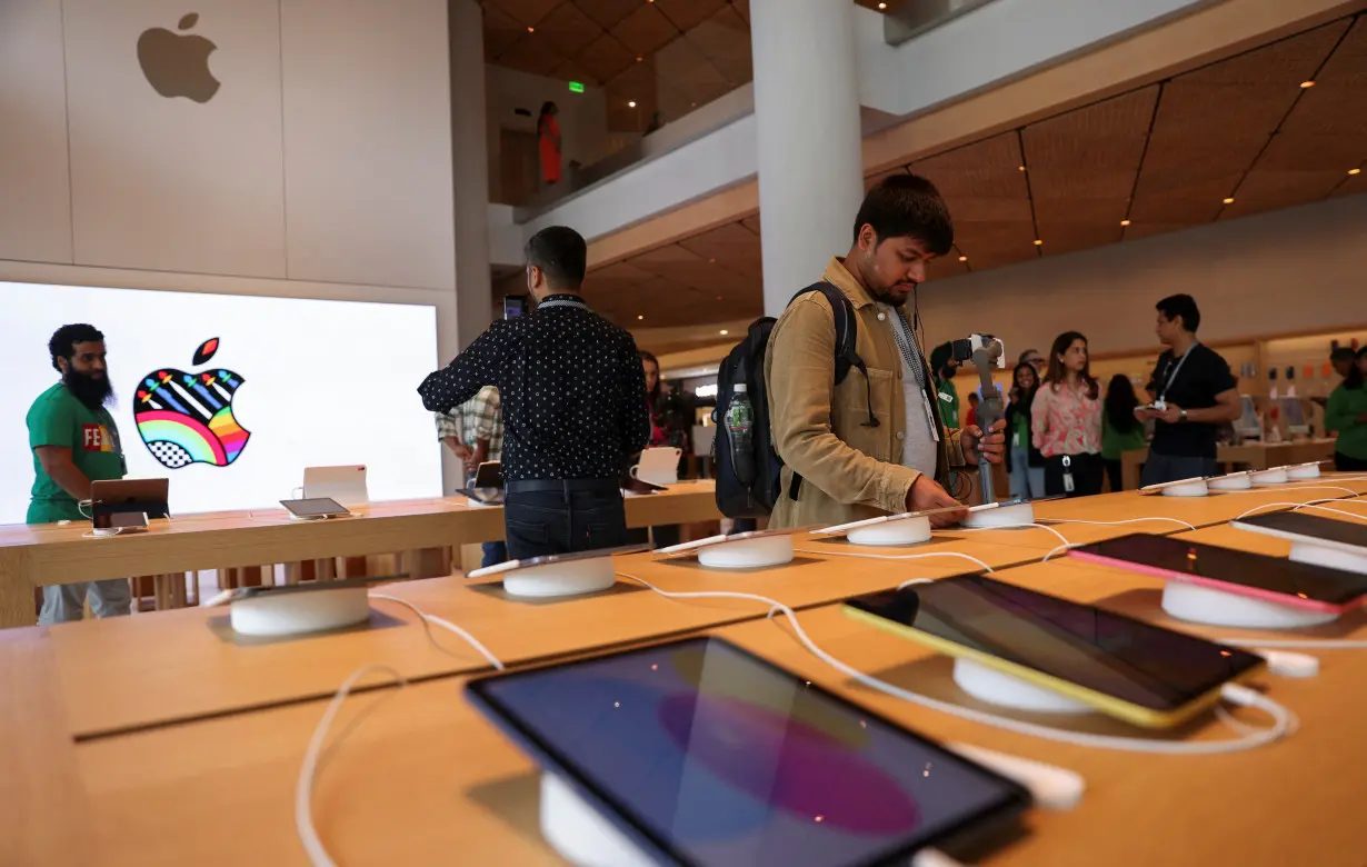 Bloggers and other journalists attend a media preview inside India's first Apple retail store, a day ahead of its launch, in Mumbai