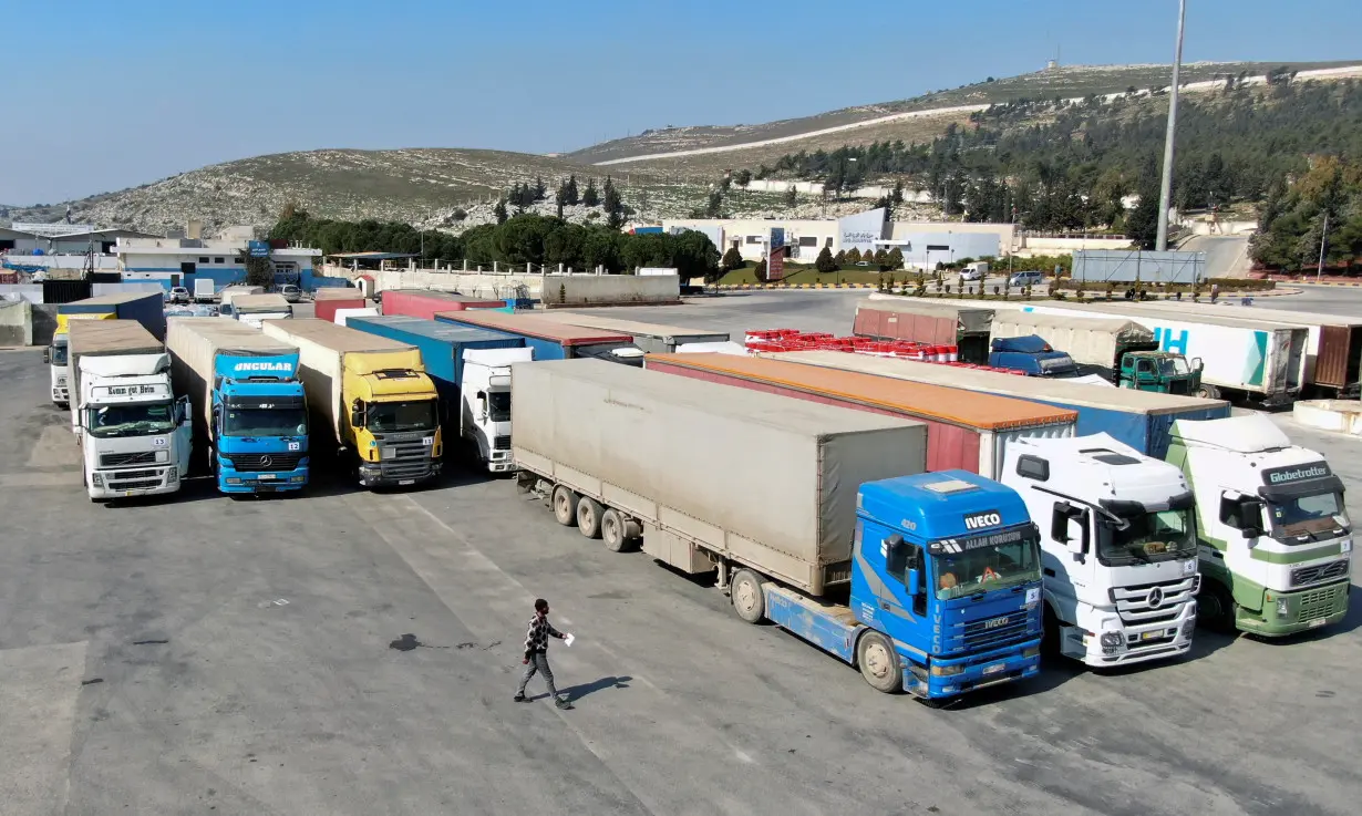 Trucks carrying aid from UN World Food Programme (WFP) are parked at Bab al-Hawa crossing