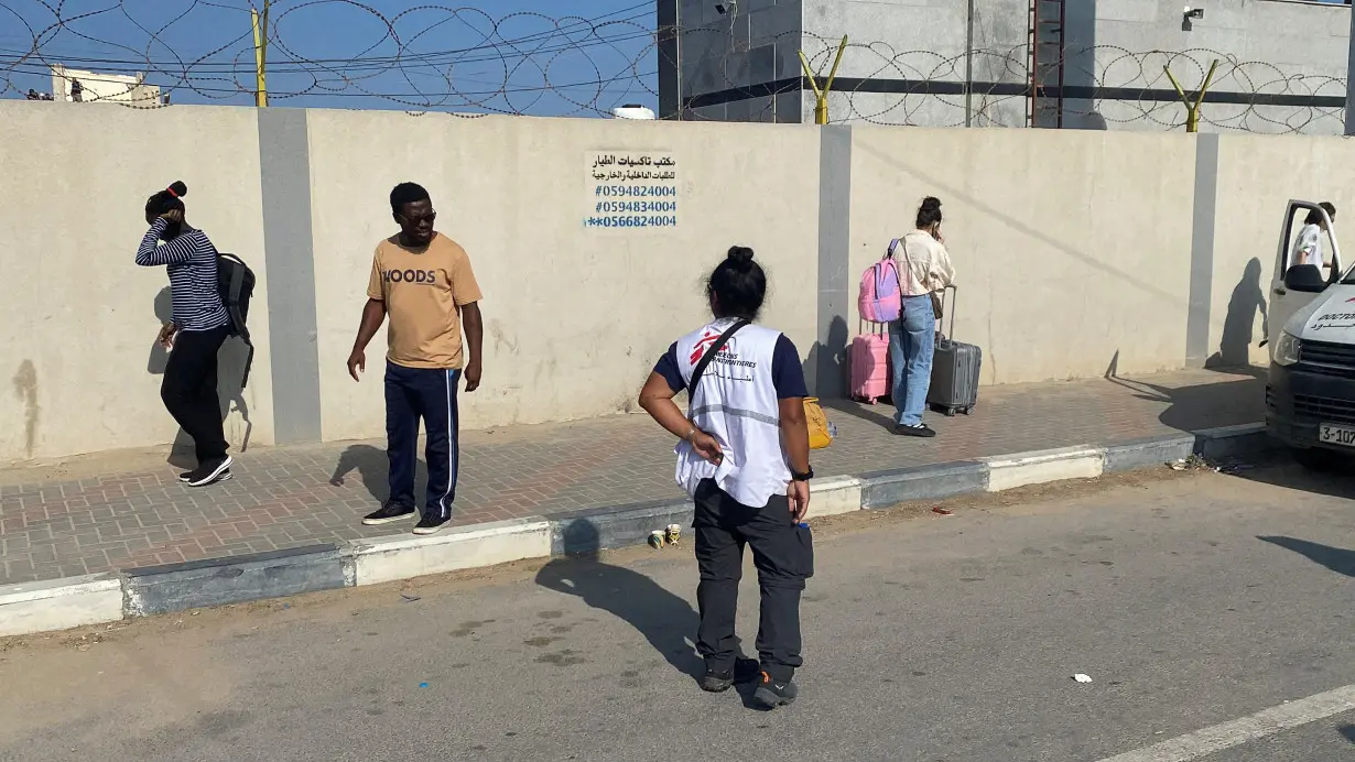 Palestinians with dual citizenship wait outside the Rafah border crossing with Egypt, in the hope of getting permission to leave Gaza