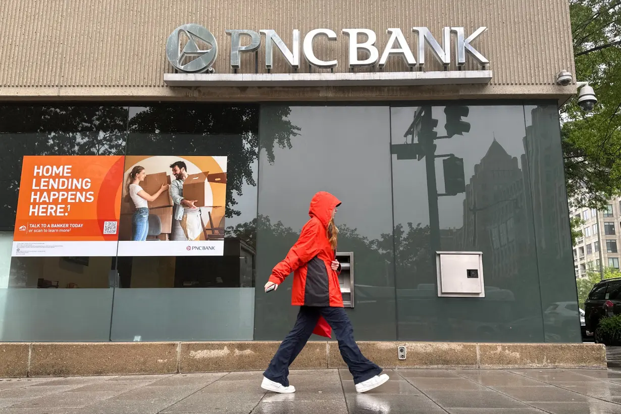 Person walks past a branch of PNC Bank, a subsidiary of PNC Financial Services Group, in Washington