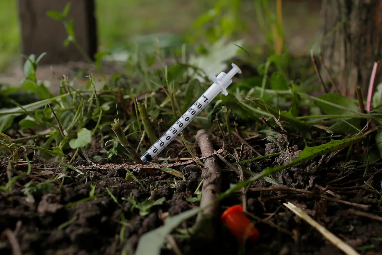 FILE PHOTO: A used needle sits on the ground in a park in Lawrence