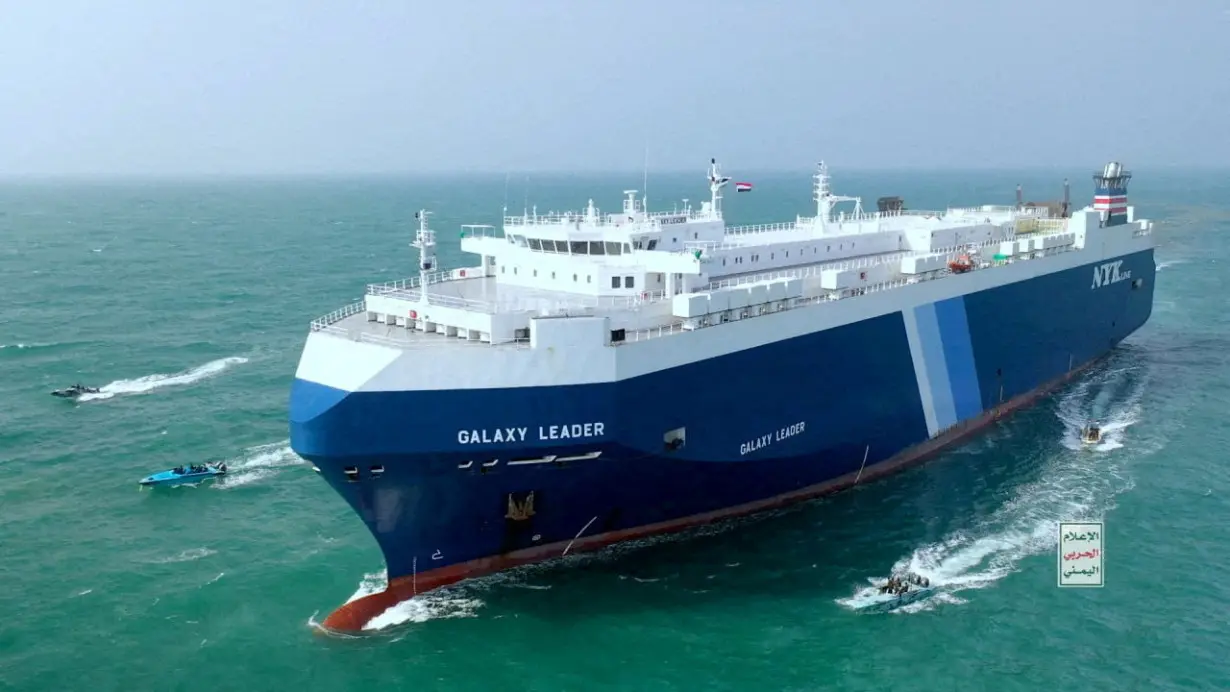 FILE PHOTO: The Galaxy Leader cargo ship is escorted by Houthi boats in the Red Sea