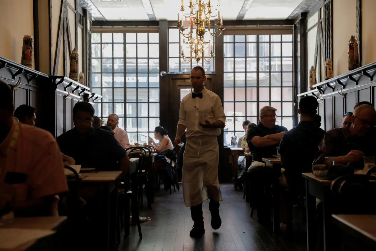FILE PHOTO: A waiter walks among diners at Peter Luger Steak House in Brooklyn, New York City