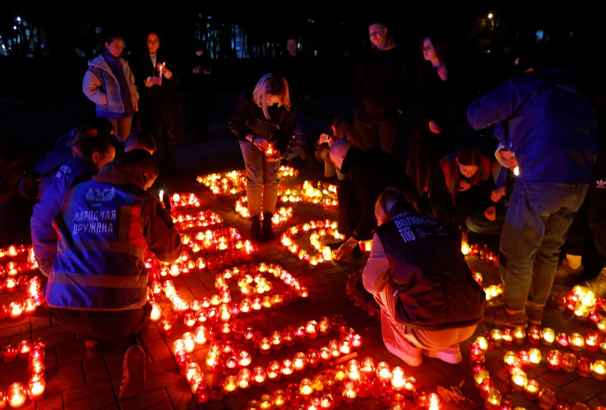 People pay tribute to the victims of a shooting attack at Moscow concert hall, in Donetsk