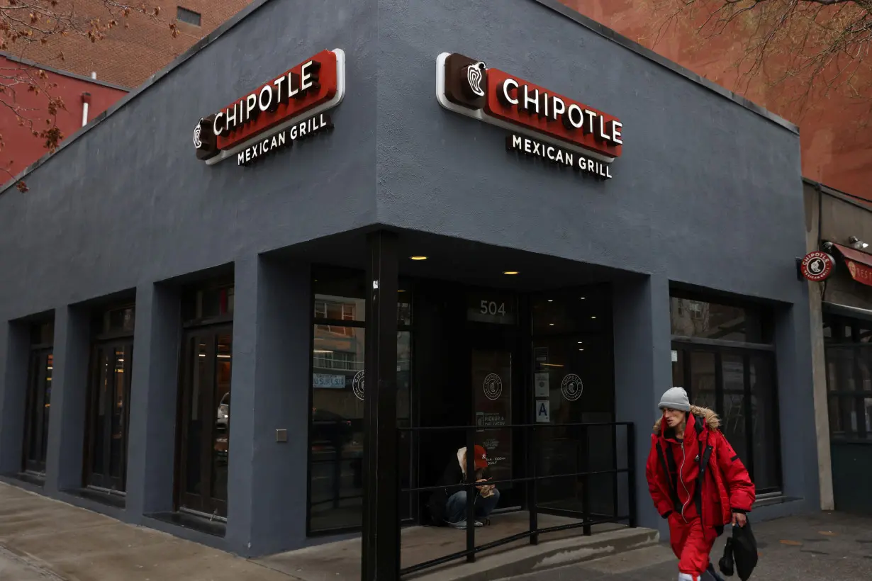 FILE PHOTO: A person walks by a Chipotle in Manhattan, New York City