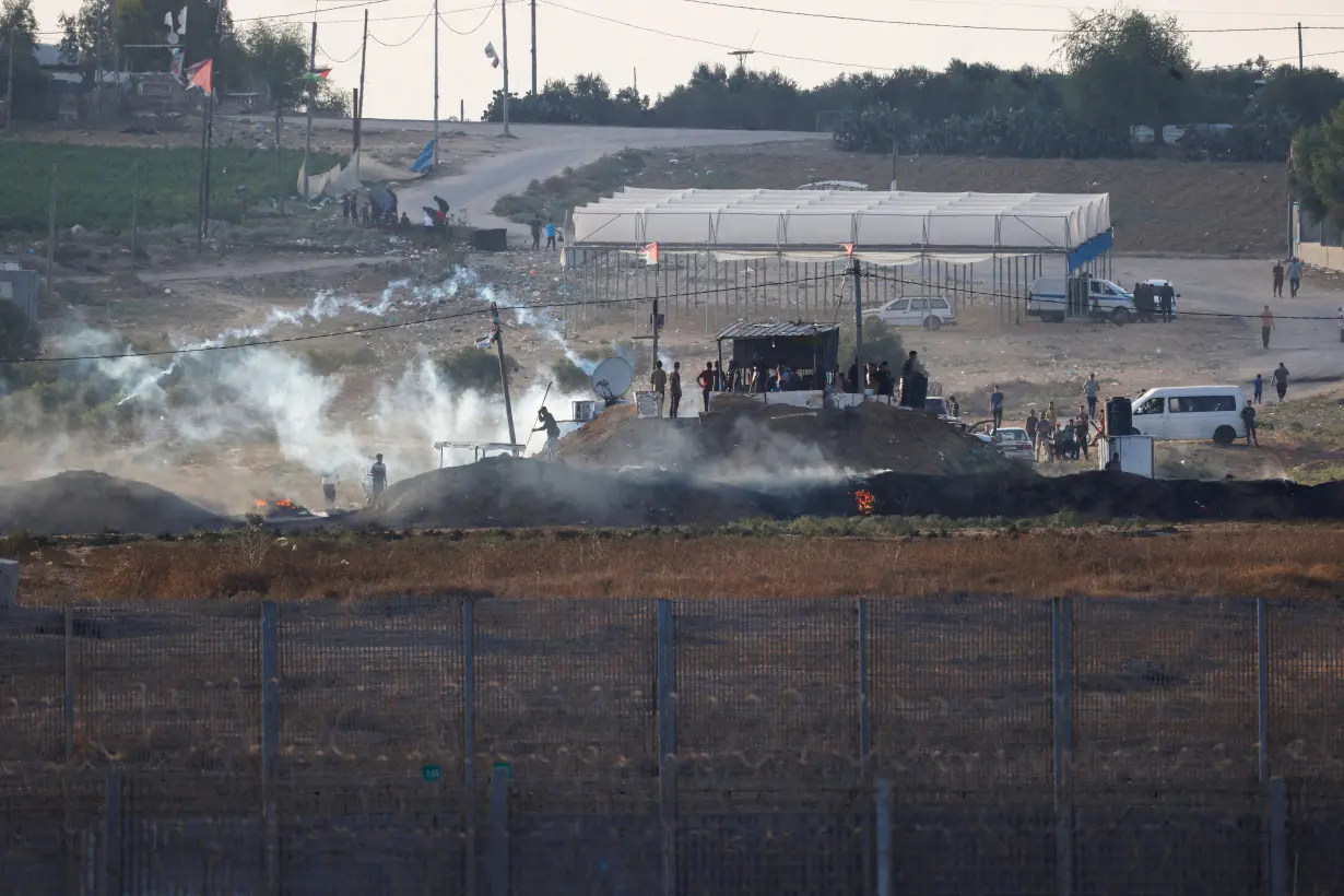 Israeli soldiers and Palestinian protesters clash near the border between Israel and the Gaza Strip as seen from the Israeli side