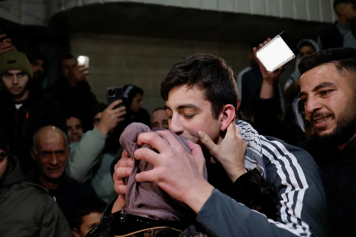 Released Palestinian prisoner Khalil Zamareh kisses his mother as he is received by his family outside his house near Hebron