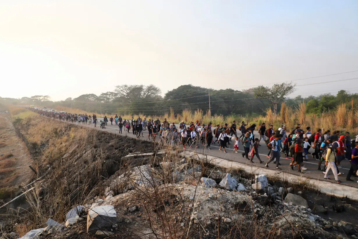 Migrants walk in a caravan as an attempt to reach the U.S. border, in Arriaga