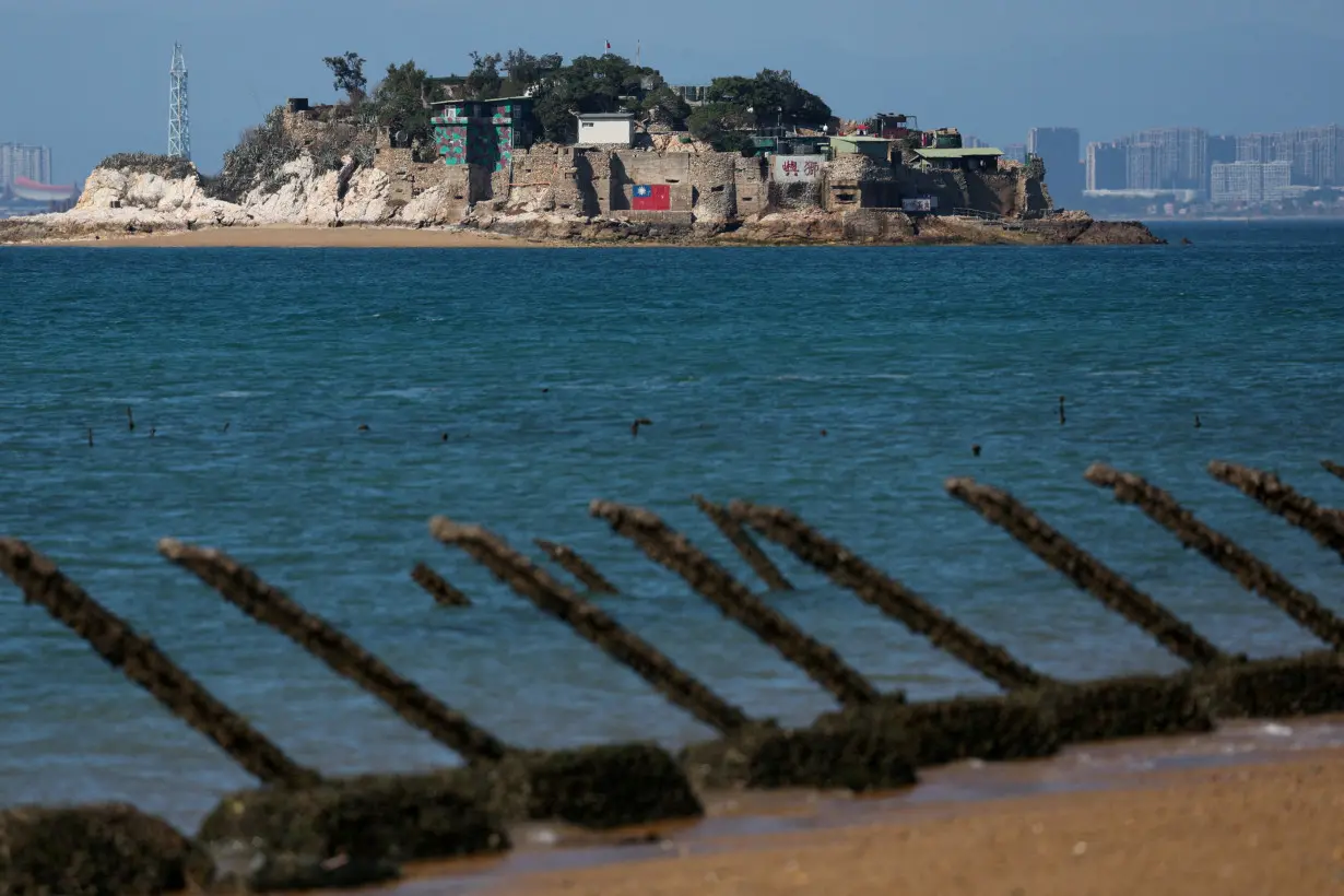 FILE PHOTO: Shiyu or Lion Islet, which is part of Kinmen County, one of Taiwan's offshore islands, is pictured with China's Xiamen in the background, in Kinmen