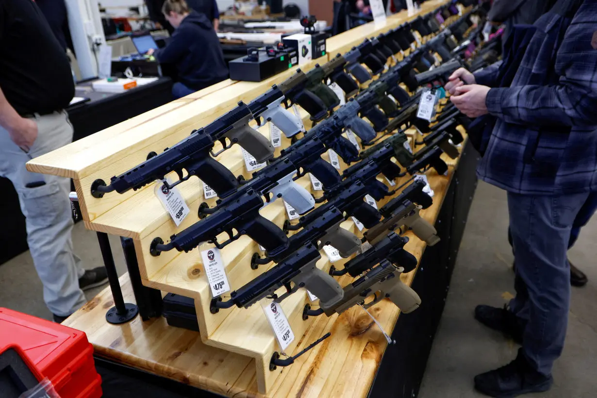 FILE PHOTO: Customers shop at the Des Moines Fairgrounds Gun Show at the Iowa State Fairgrounds in Des Moines, Iowa