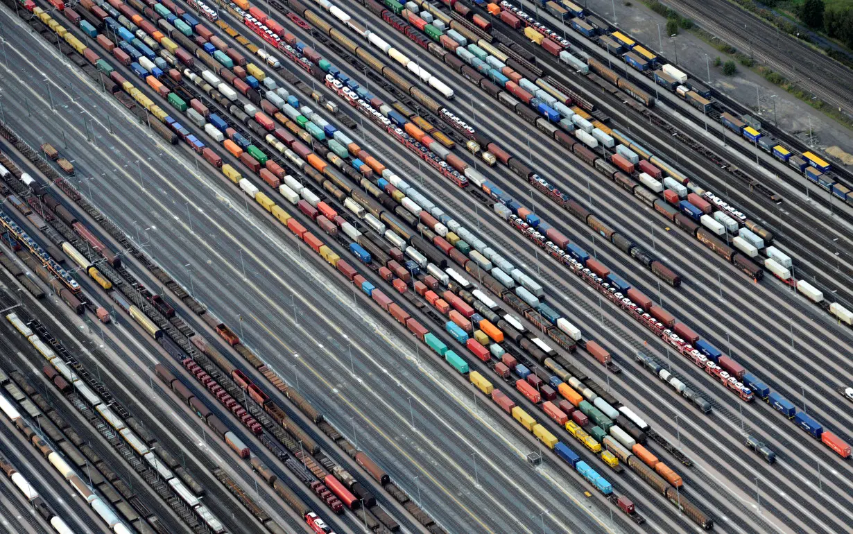 Containers and cars are loaded on freight trains at the railroad shunting yard in Maschen near Hamburg