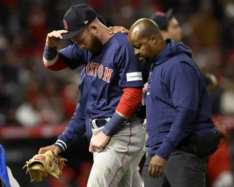 Red Sox SS Trevor Story leaves game after injuring shoulder on diving stop of Mike Trout's hit