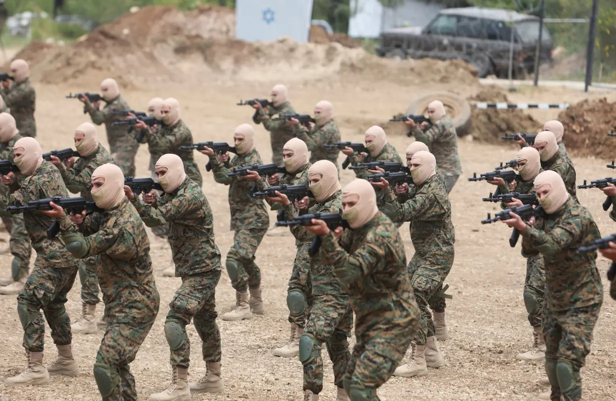 Hezbollah members take part in a military exercise during a media tour organized for the occasion of Resistance and Liberation Day, in Aaramta