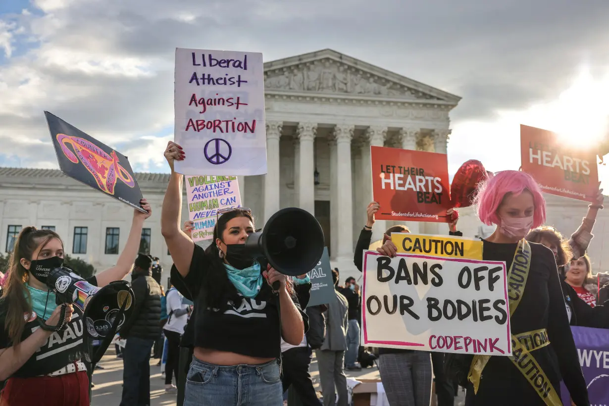 FILE PHOTO: Protestors demonstrate outside U.S. Supreme Court as the court weighs Texas abortion law