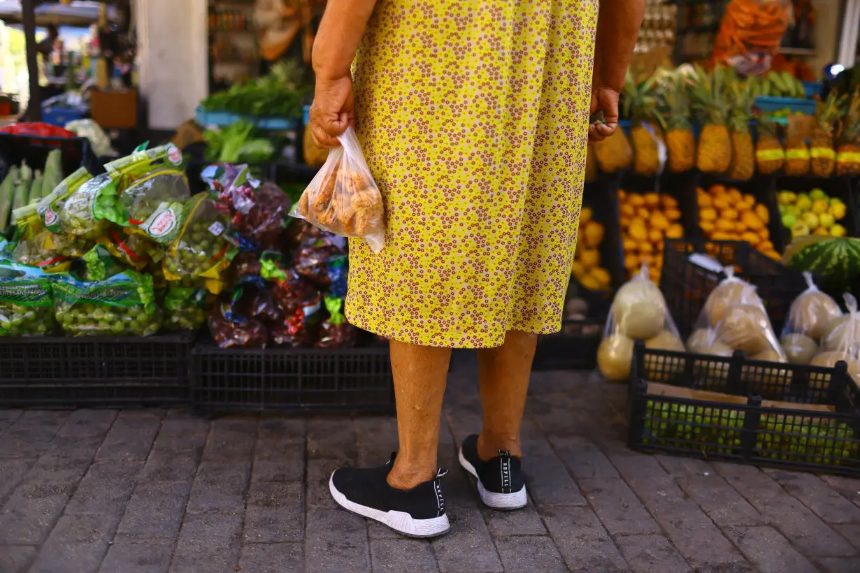 FILE PHOTO: Martha Meza stands in front of a stall in an outdoor market dedicated to the sale of fruits and vegetables, in downtown of Ciudad Juarez