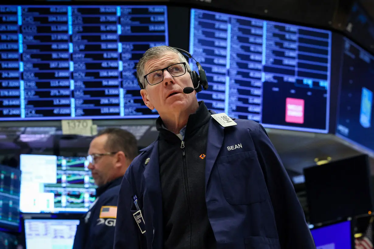 FILE PHOTO: Traders work on the floor of the NYSE in New York