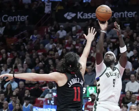 Antetokounmpo, Lillard combine for 65, and Bucks earn quarterfinal berth by topping Heat 131-124