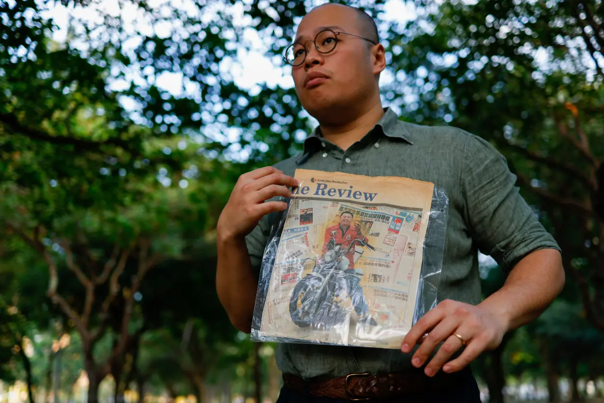 Sebastien Lai, son of Hong Kong media tycoon Jimmy Lai poses with a newspaper clip of his father in Taipei