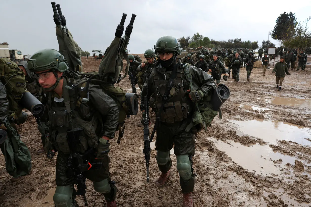 Israeli soldiers prepare to enter the Gaza Strip, amid the ongoing conflict between Israel and the Palestinian Islamist group Hamas, at Israel's border with Gaza in southern Israel