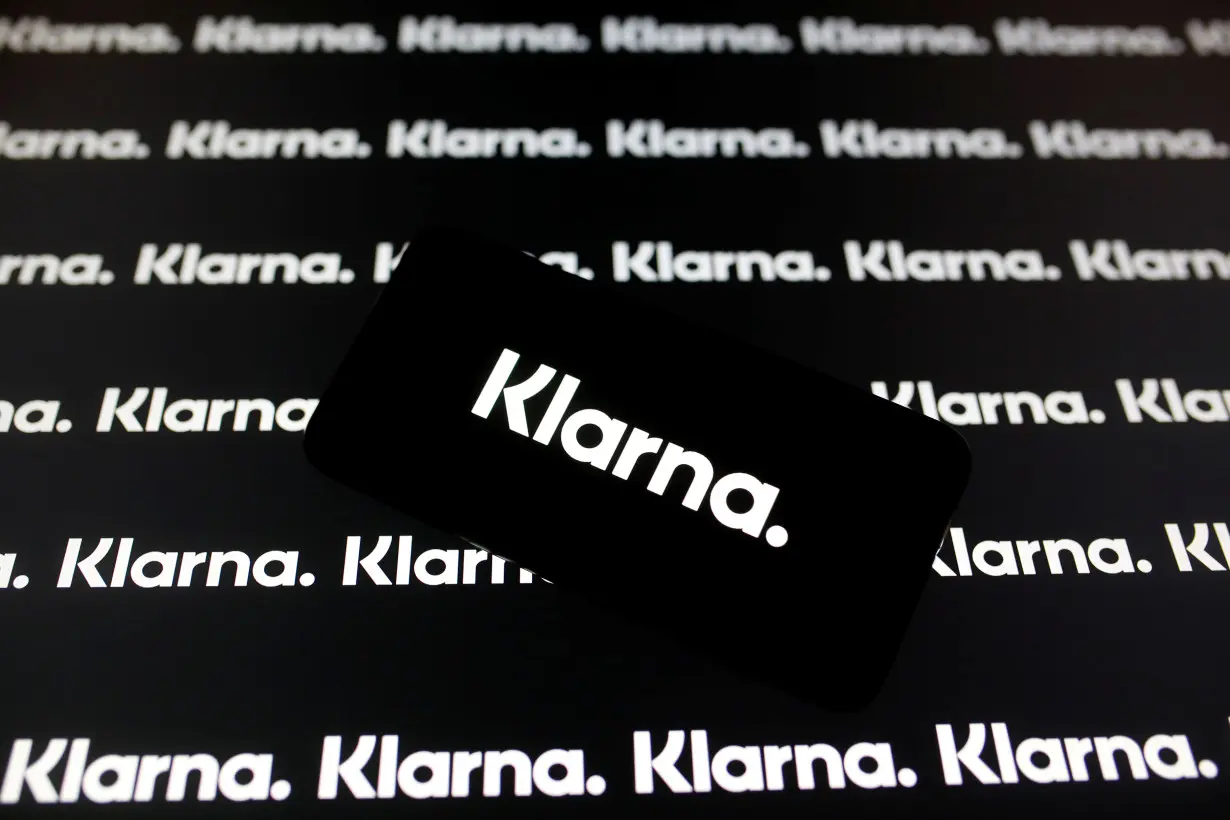 A smartphone displays a Klarna logo in this illustration