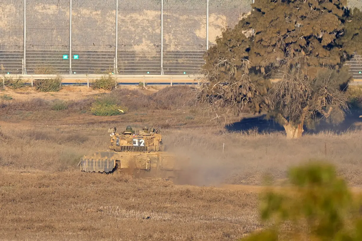 A Merkava tank manoeuvres near the Gaza Strip, as seen from southern Israel, amid the ongoing conflict between Israel and the Palestinian group Hamas