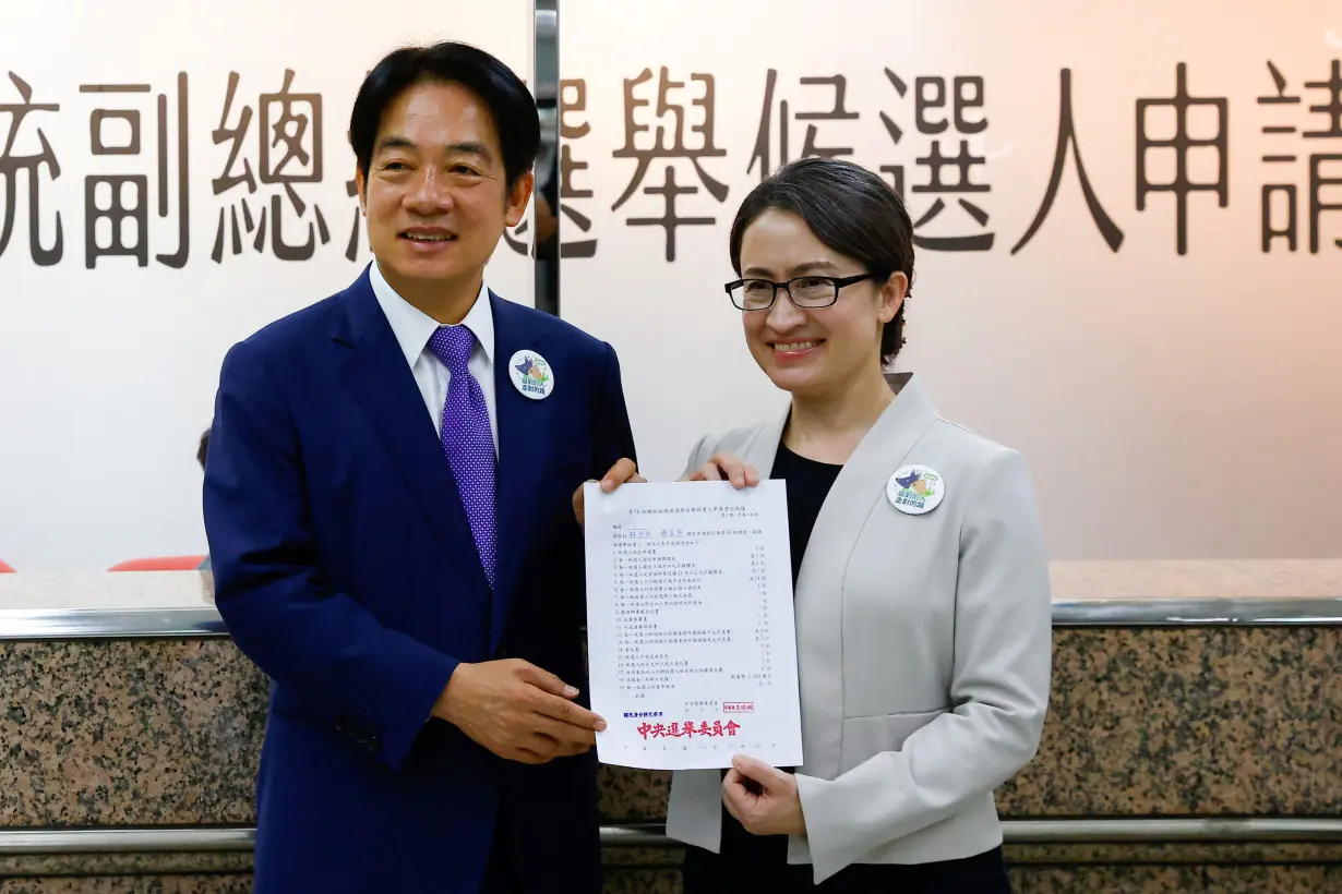 Taiwan's Vice President Lai Ching-te and running mate Hsiao Bi-Khim pose for a photo after registering for the upcoming presidential election, in Taipei