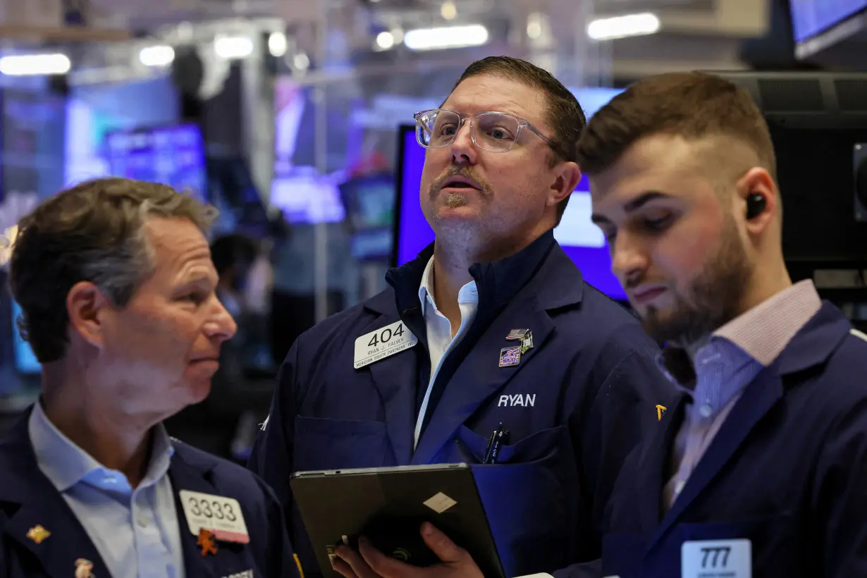 Traders work on the floor of the NYSE in New York