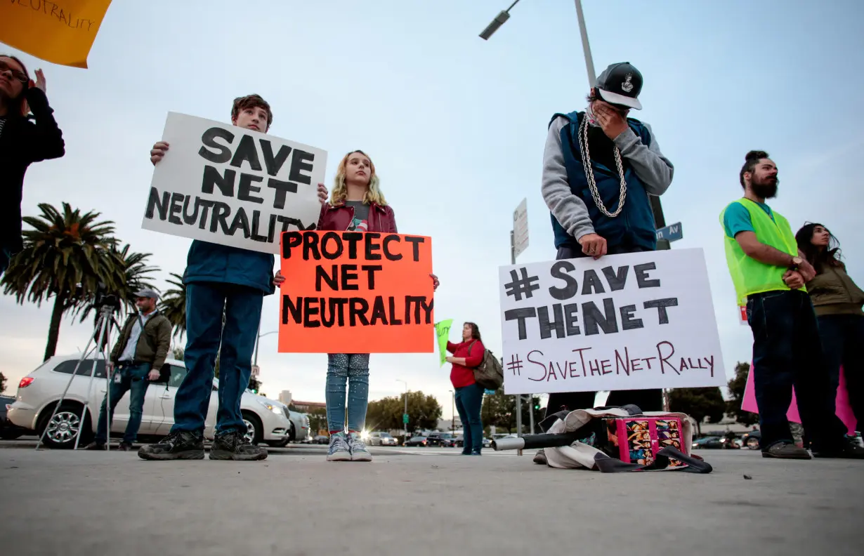 FILE PHOTO: Supporters of Net Neutrality protest the FCC's decision to repeal the program in Los Angeles