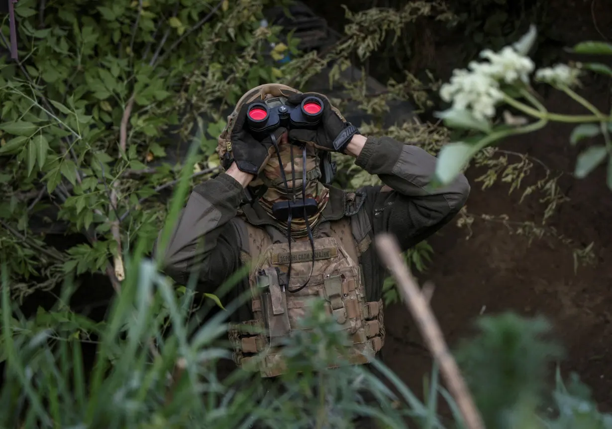 FILE PHOTO: A Ukrainian serviceman from an air defence unit monitors the sky at a frontline near the town of Bakhmut