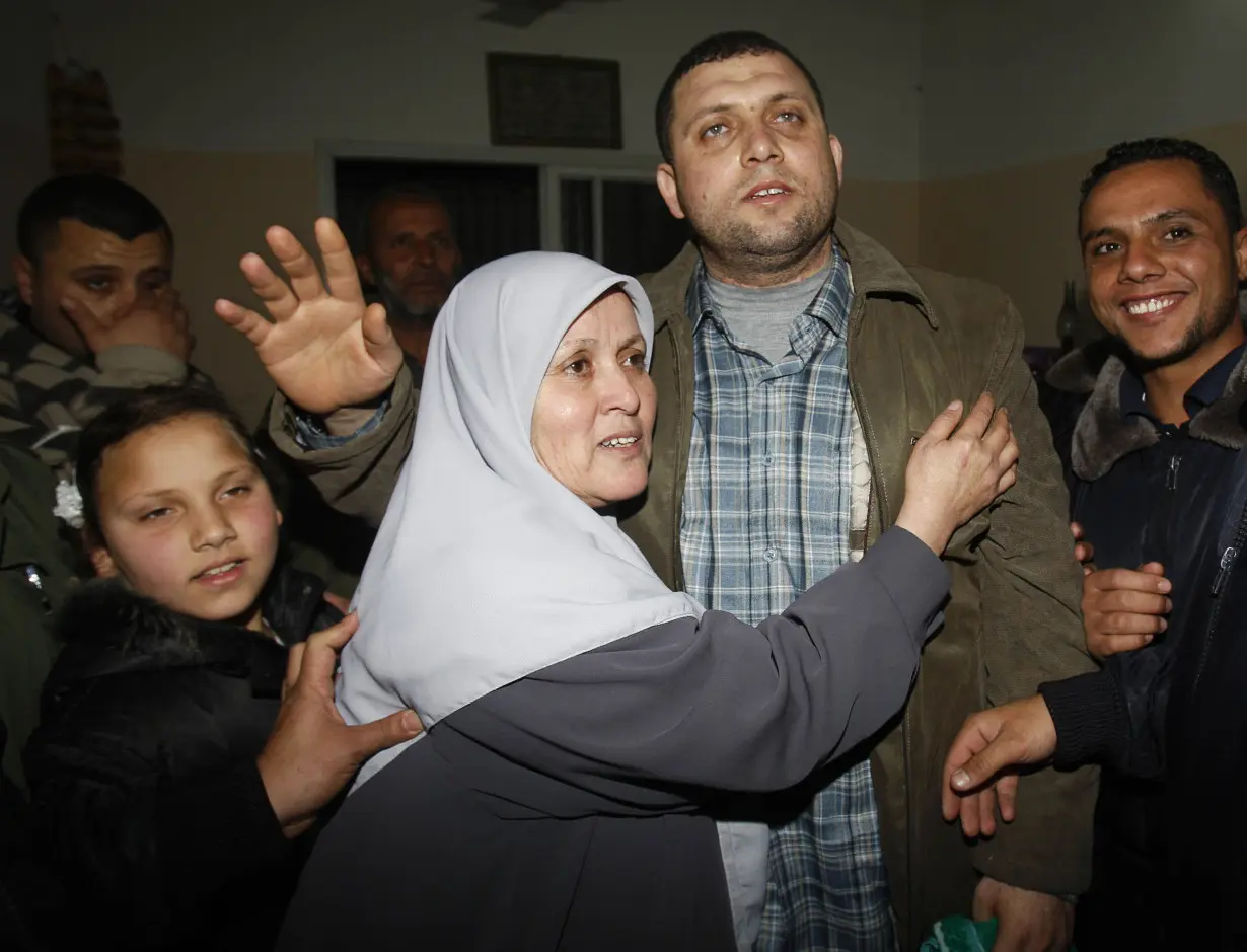 Ayman Nofal, a top Hamas armed commander, is greeted by his relatives upon his arrival to his home in Nusairat in the Central Gaza strip