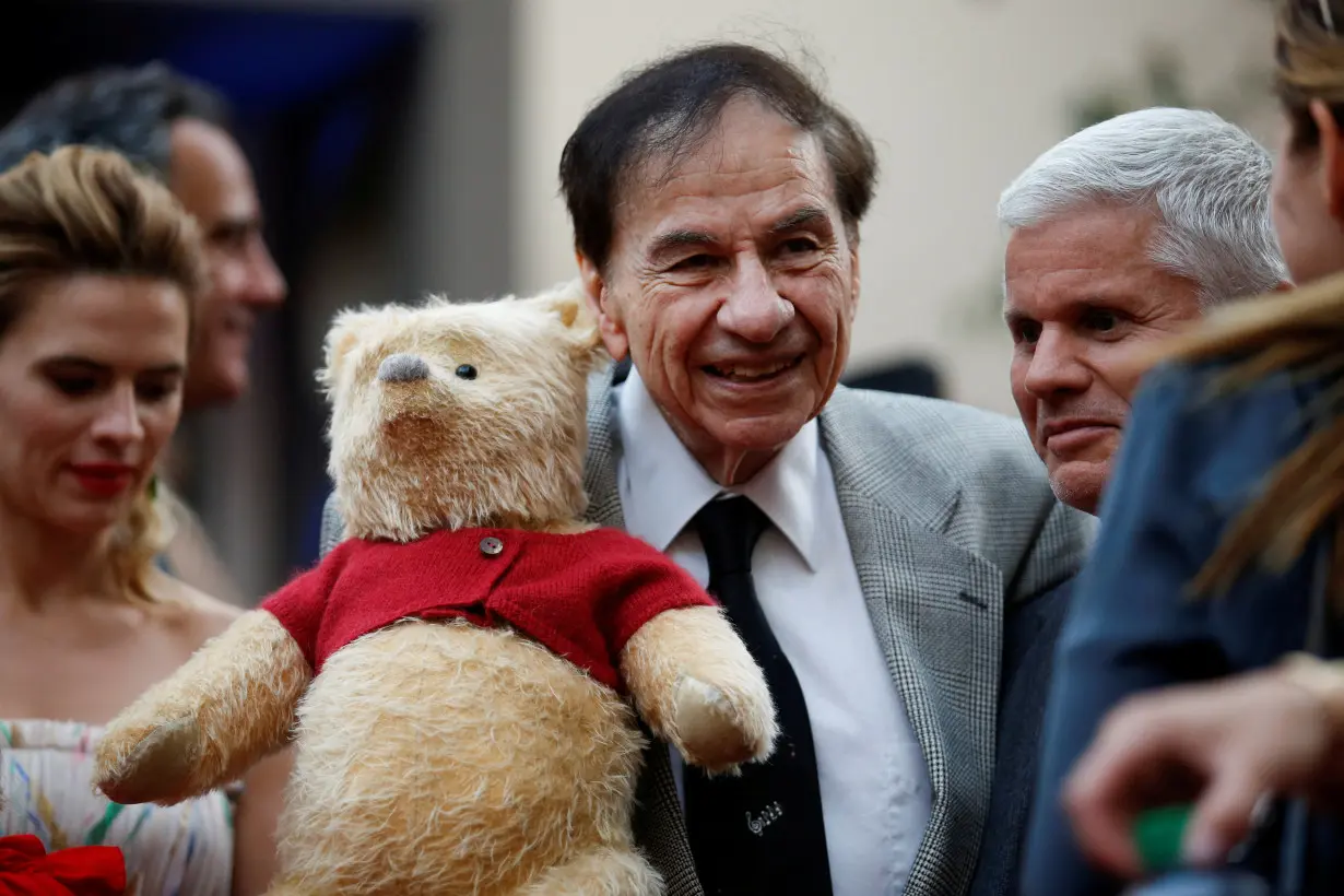 FILE PHOTO: Songwriter Richard M. Sherman holds a stuffed Winnie the Pooh as he poses at the world premiere of Disney's 
