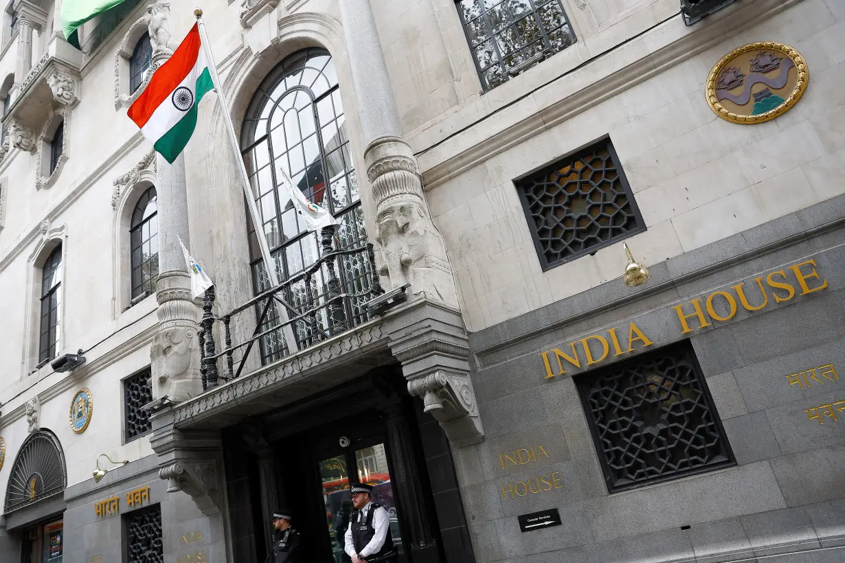 Police officers stand guard outside India House where the High Commission of India is located, in London