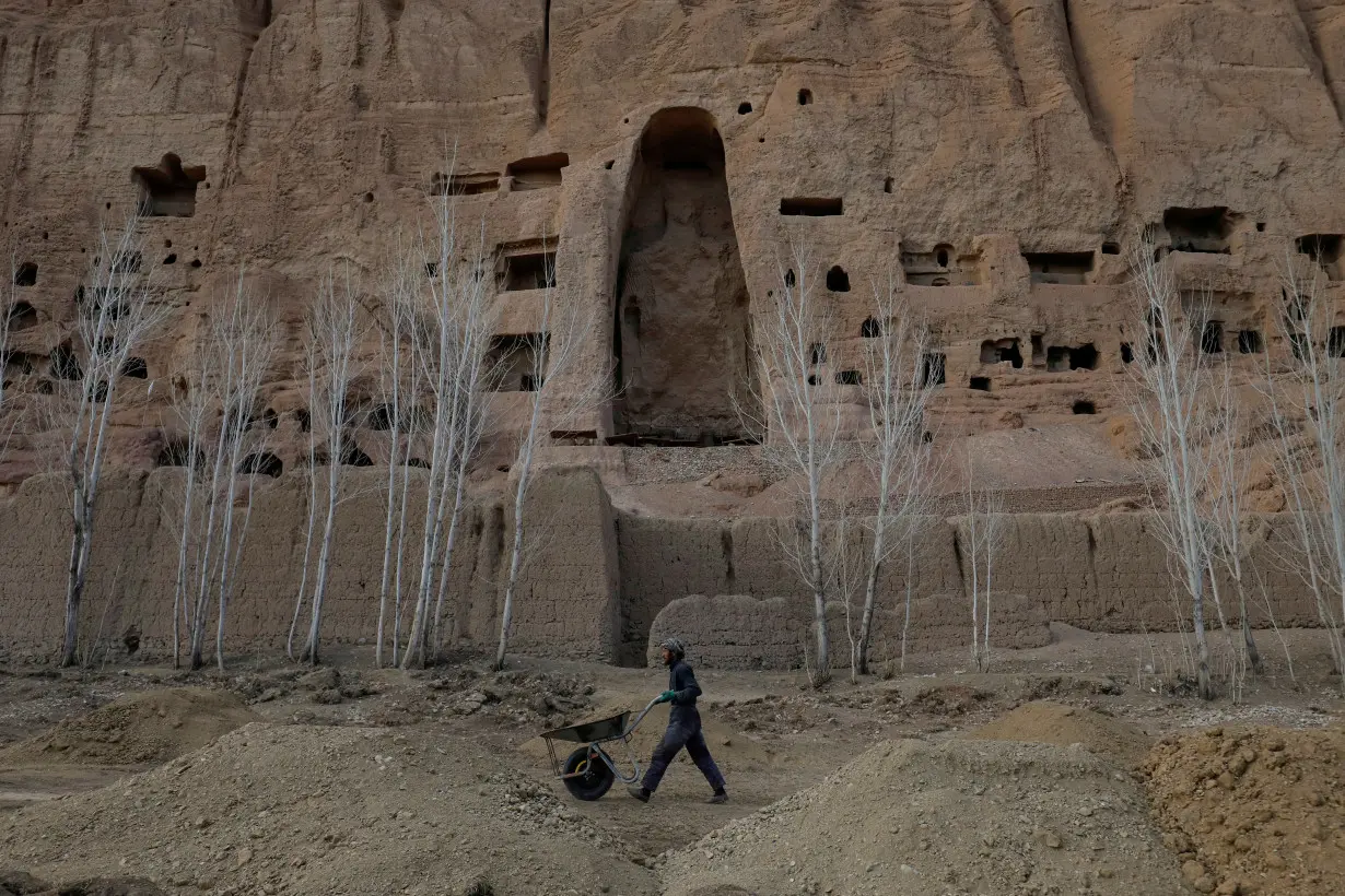 FILE PHOTO: An Afghan man works in front of the ruins of a 1500-year-old Buddha statue in Bamiyan