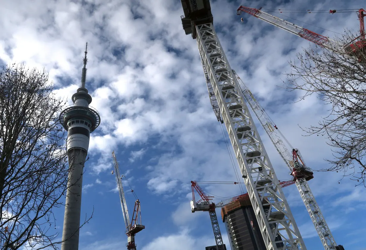 Cranes located on construction sites are seen near the Sky Tower building in central Auckland