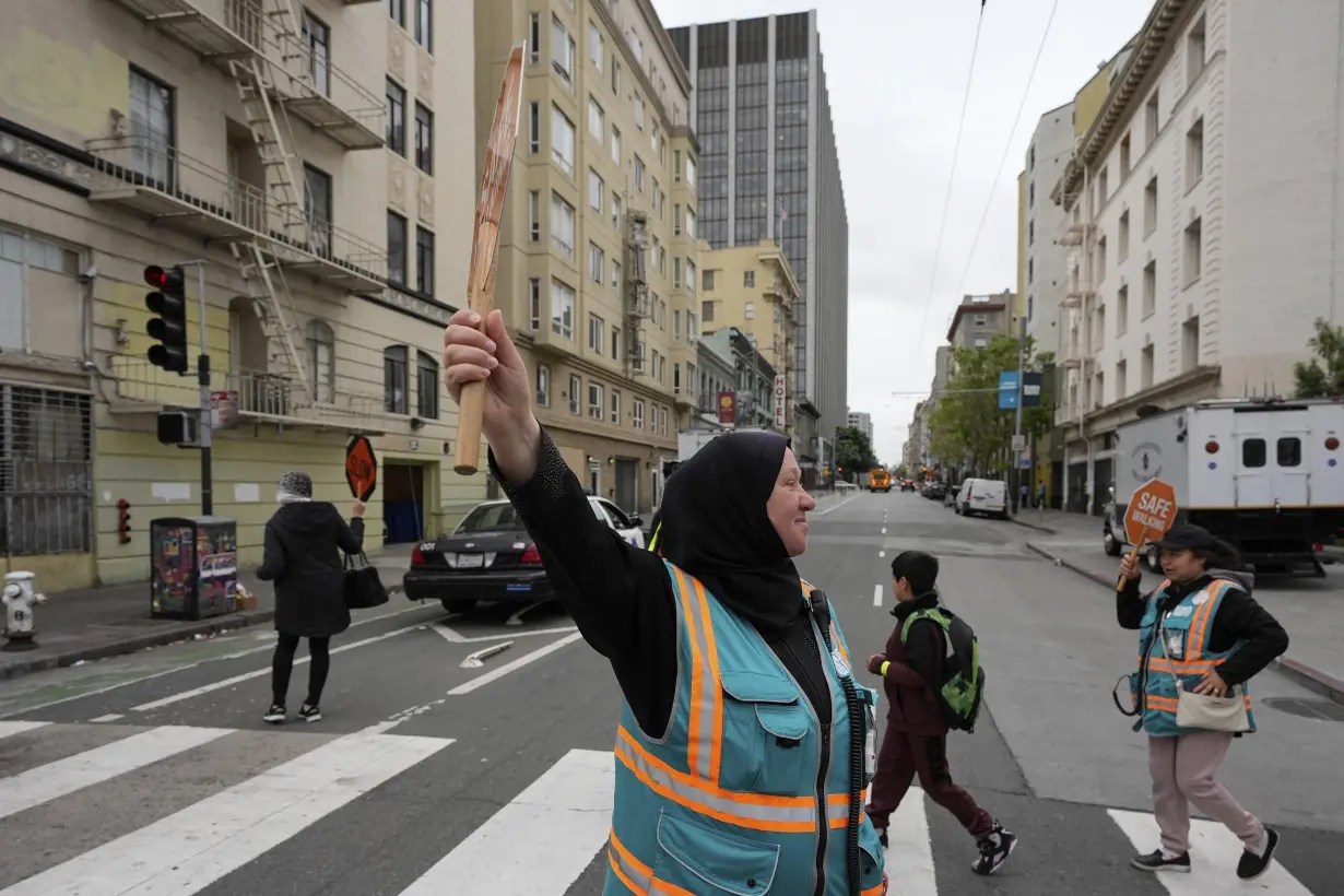 With a vest and a voice, helpers escort kids through San Francisco’s broken Tenderloin streets