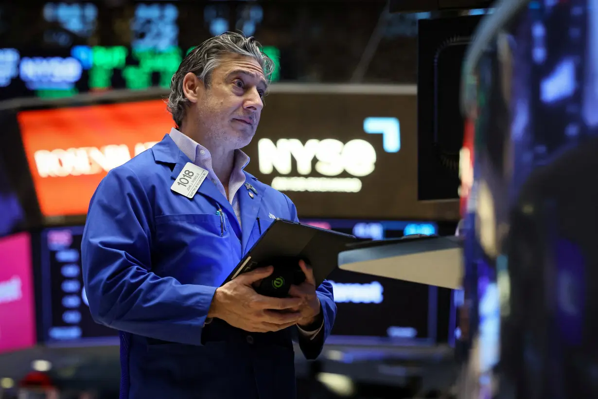 Traders work on the floor of the NYSE in New York