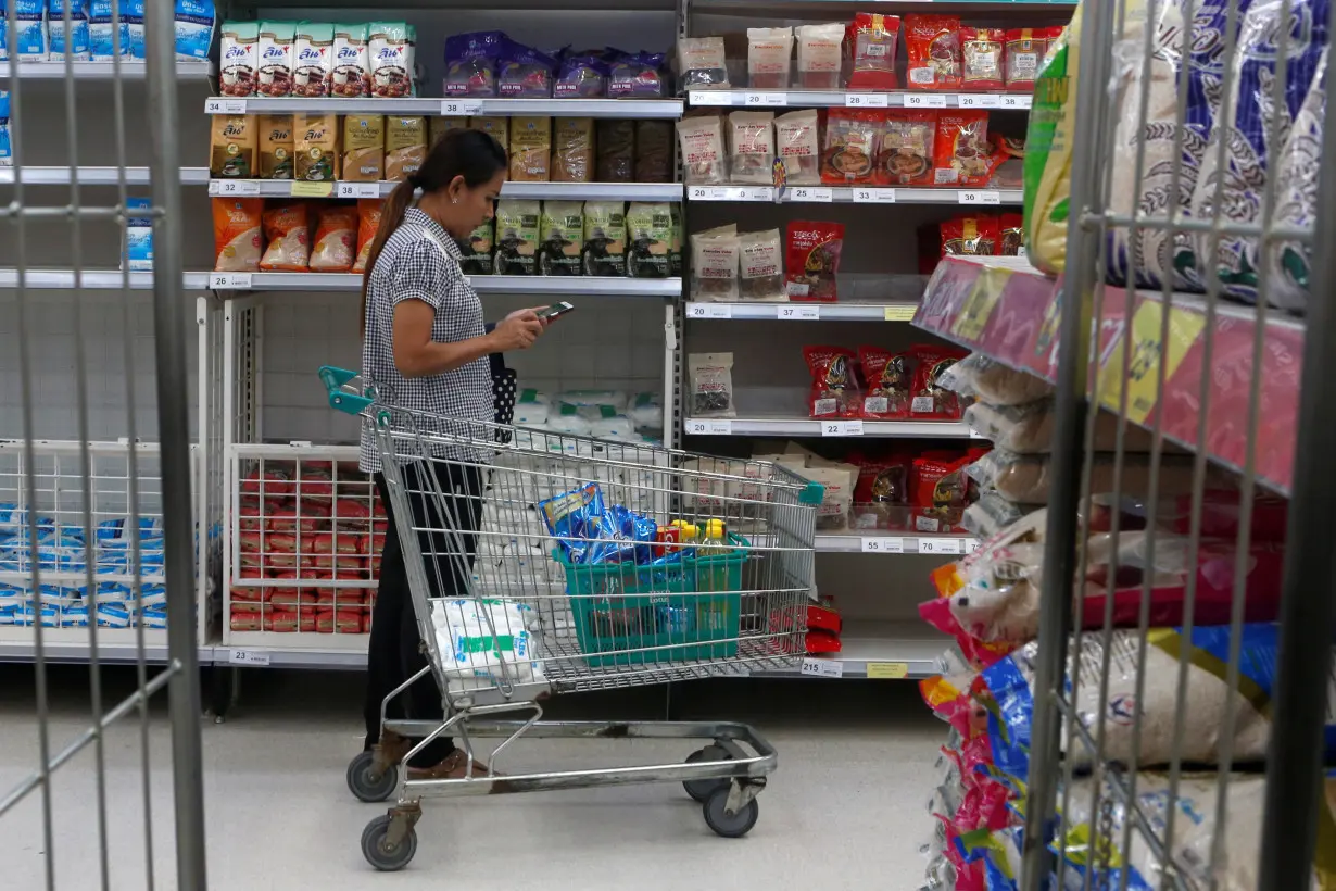 A woman shops at a supermarket inside a department store in central Bangkok